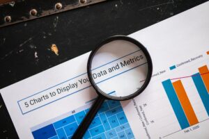 Magnifying glass examining documents related to Medicare lead providers review, symbolizing due diligence and scam prevention
